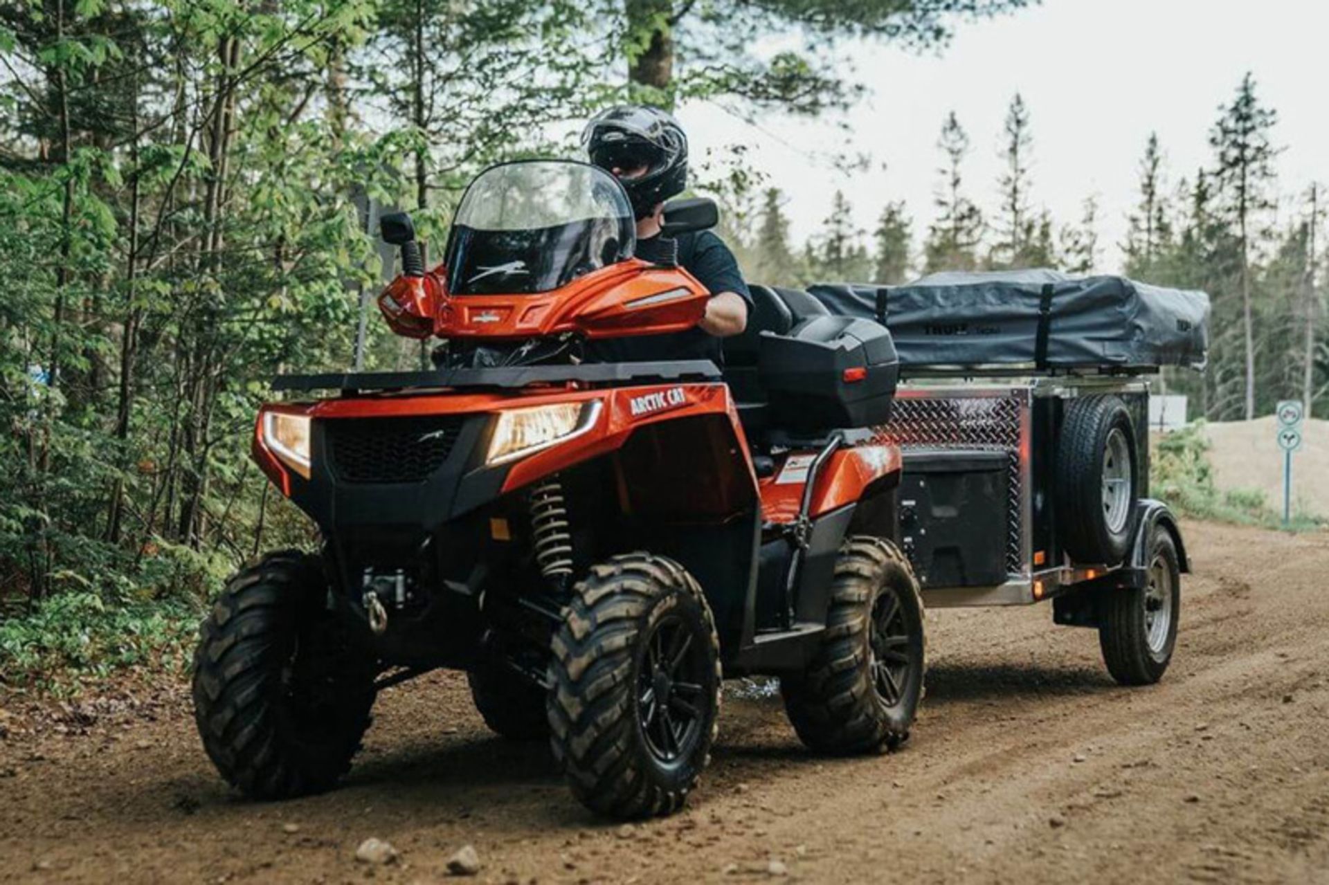 Genimax trailer moving with four-wheel engine in the forest