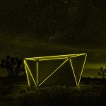 The LED lights of Jupe's folding hut at night