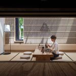 The tea table in the Blue Lake Teahouse, with a wooden lattice wall and a long window