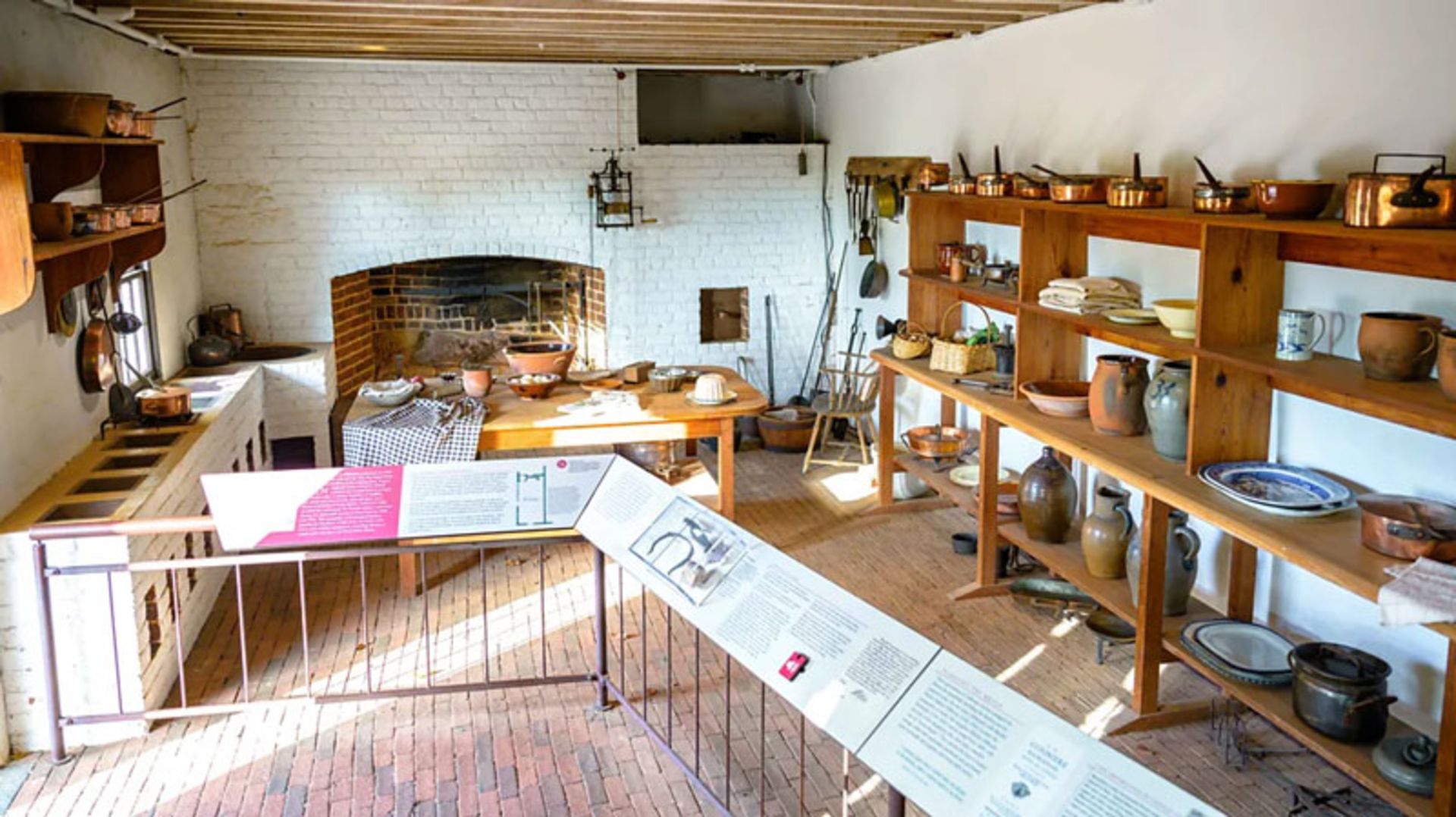 The interior of the historic Monticello kitchen, with an old copper oven and cookware