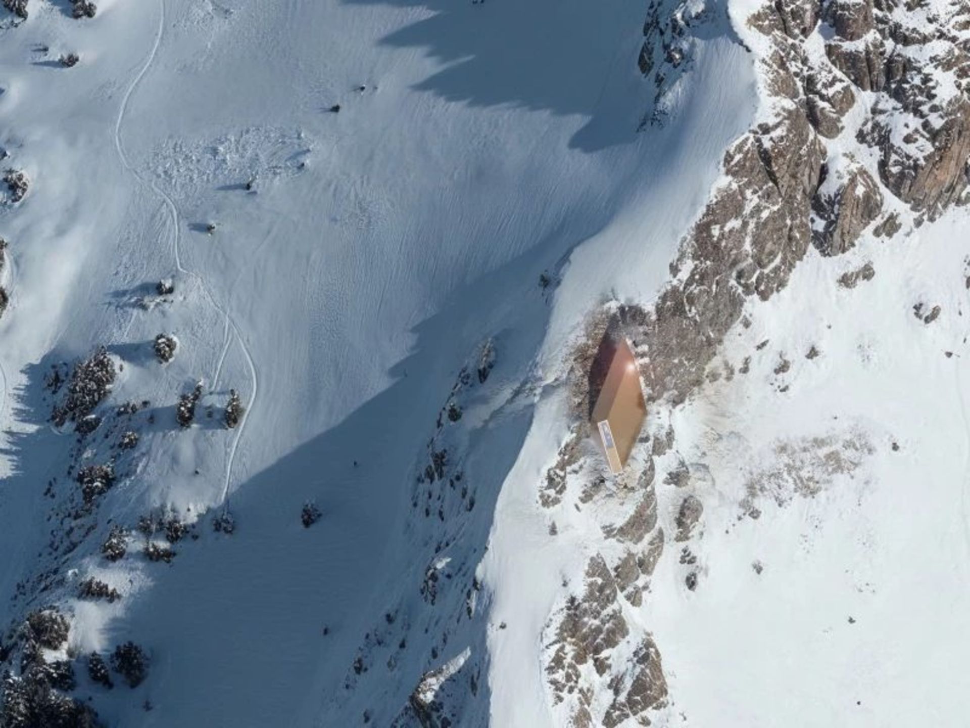 Simulation of the aerial image of the mountain lodge in the snowy Alps