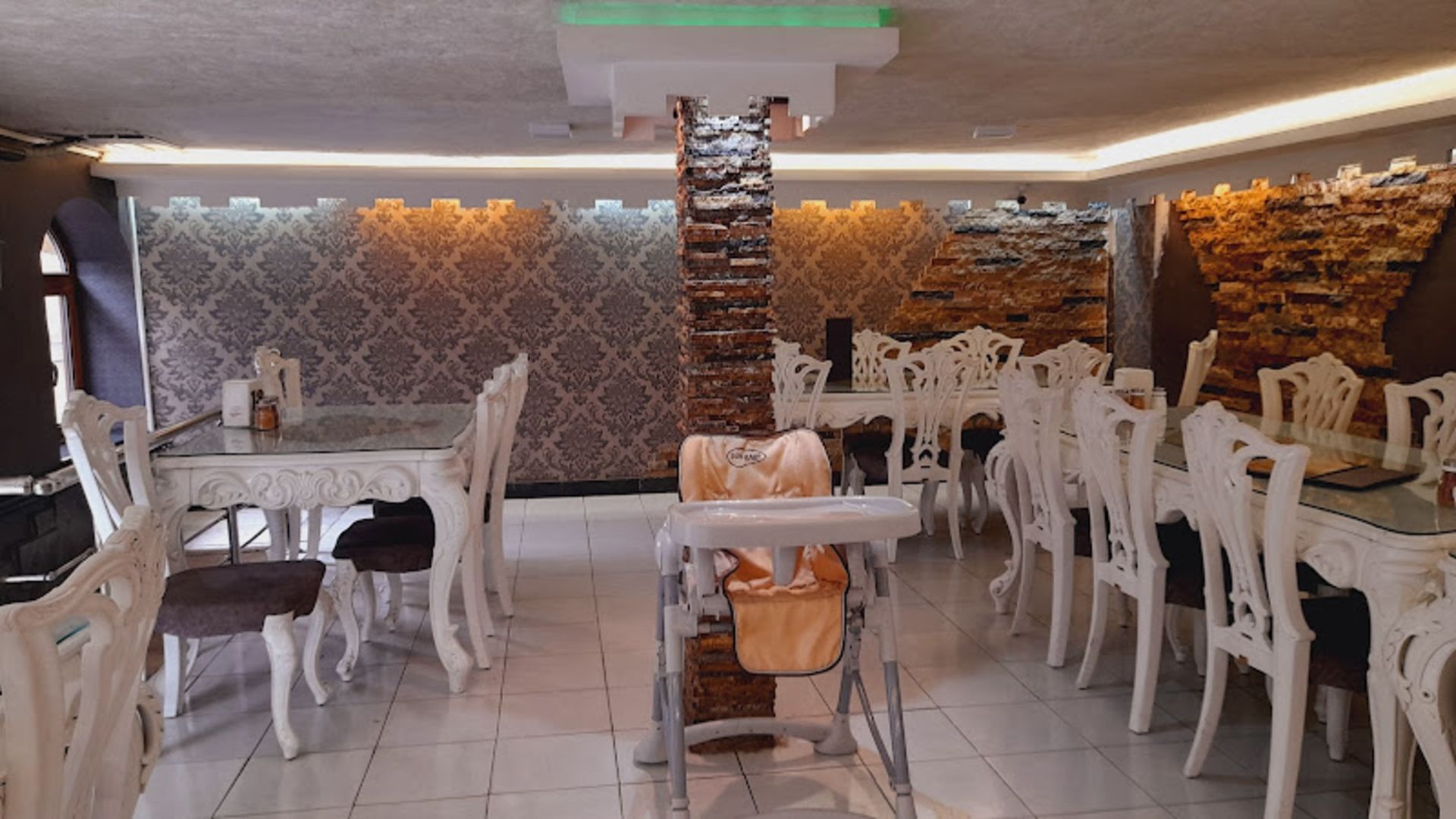 White tables and chairs of Darvish Shahroud restaurant
