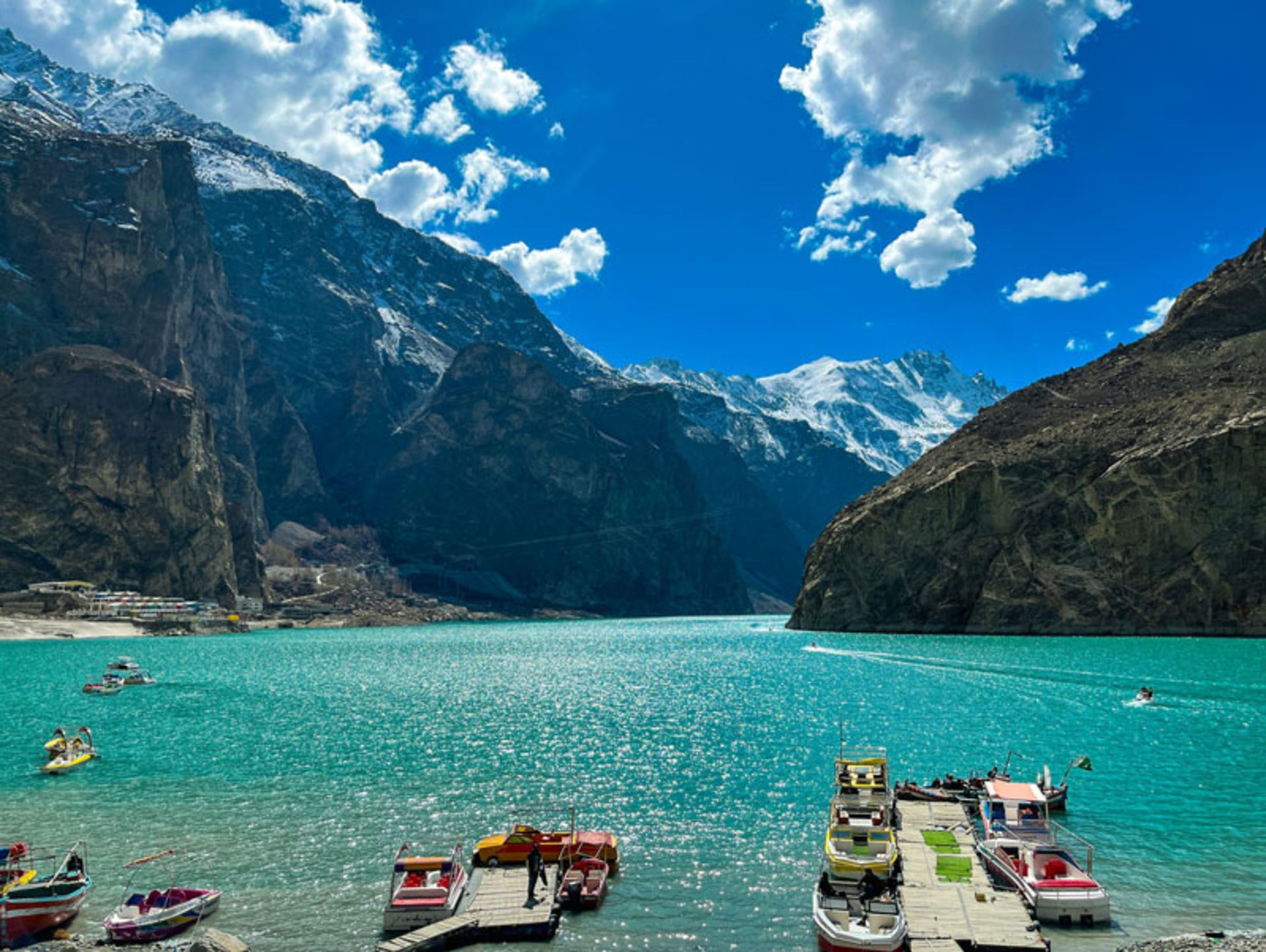 Pleasure boats next to the pier of Atabad Lake