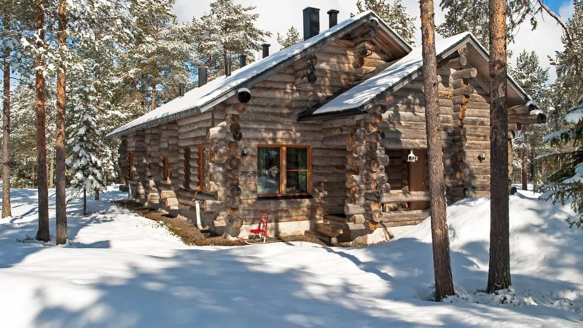 A wooden hut in the snowy forest