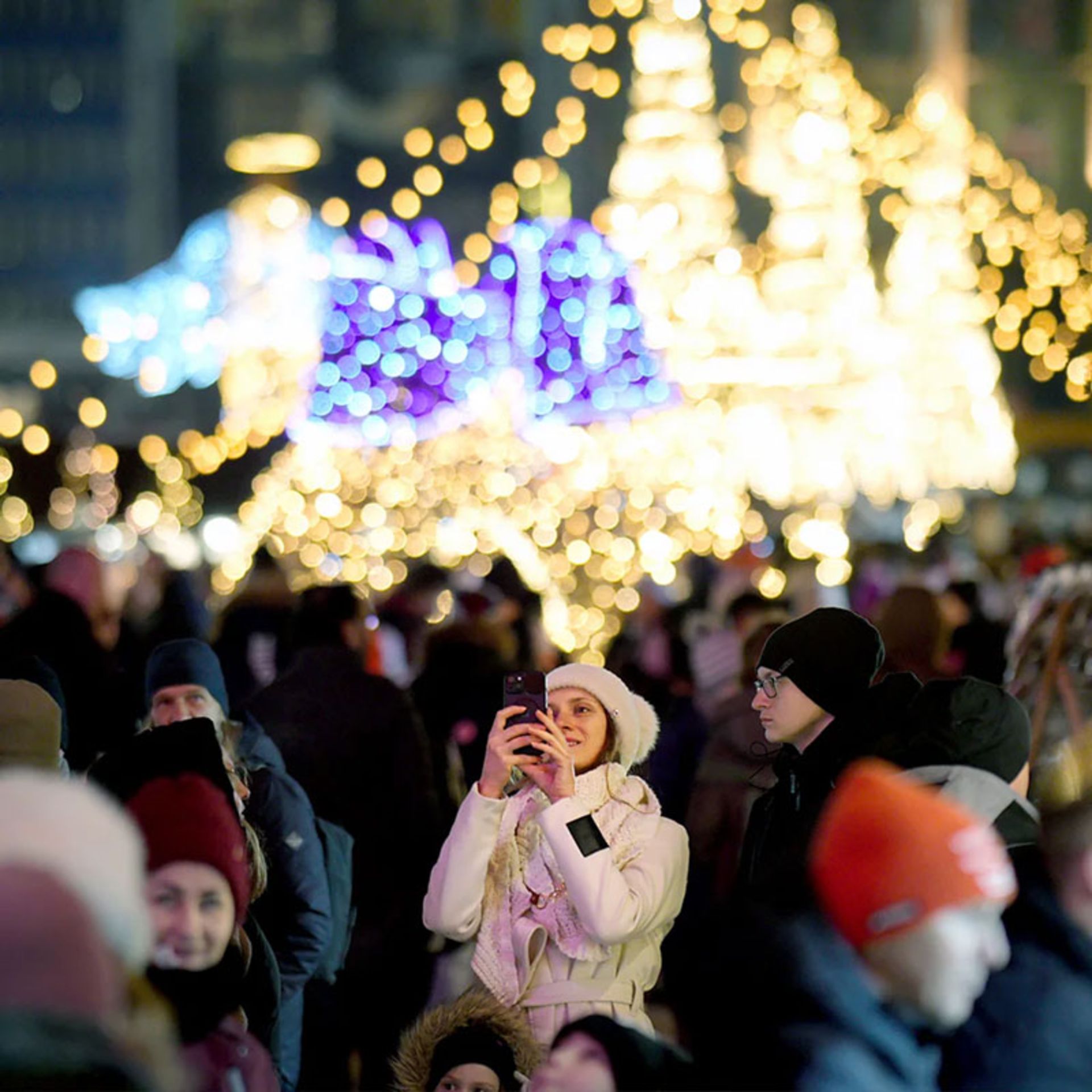 Taking a selfie in the crowd of tourists at night