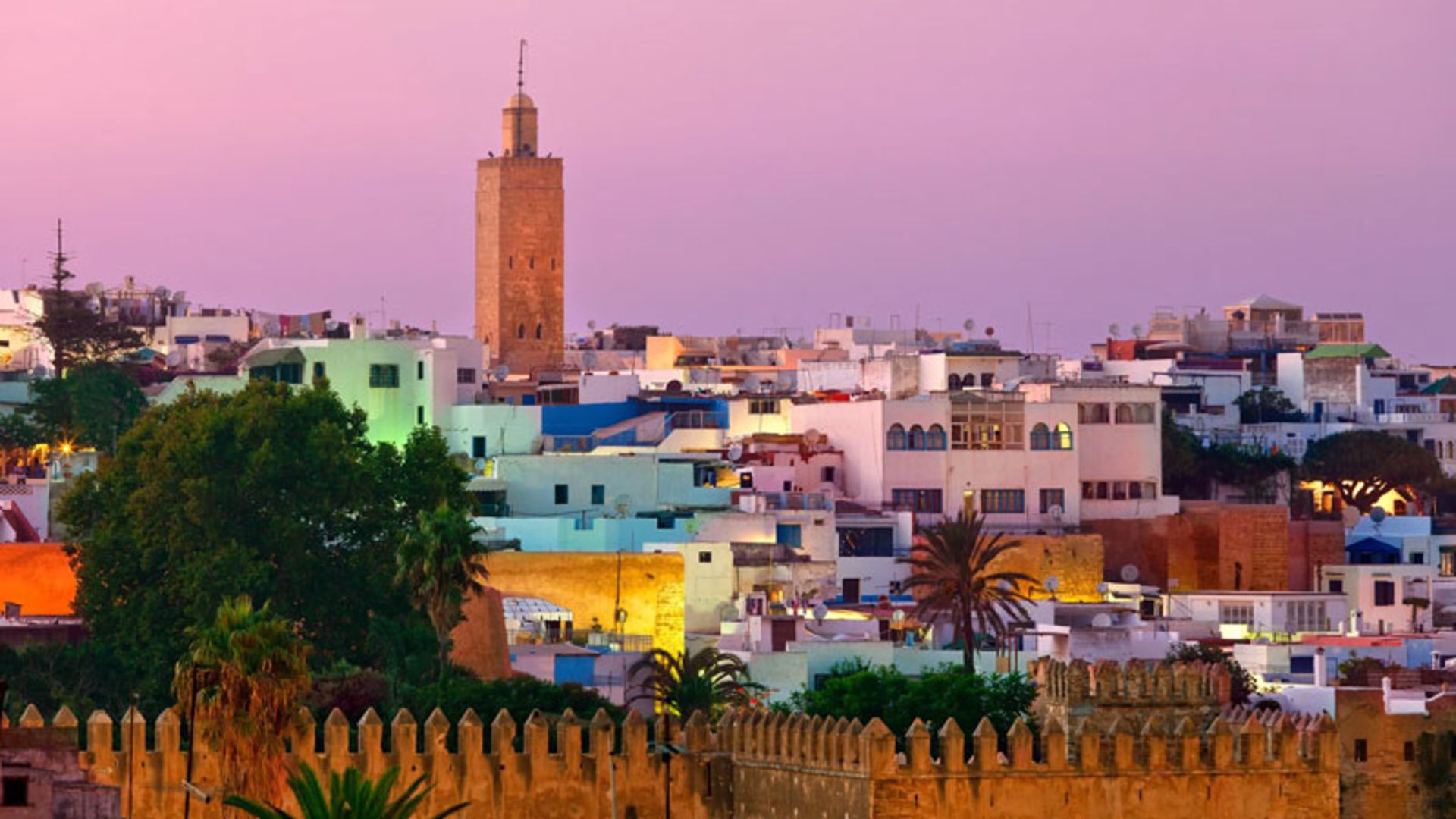 Sunset view of Rabat, Morocco with traditional buildings and a tall minaret