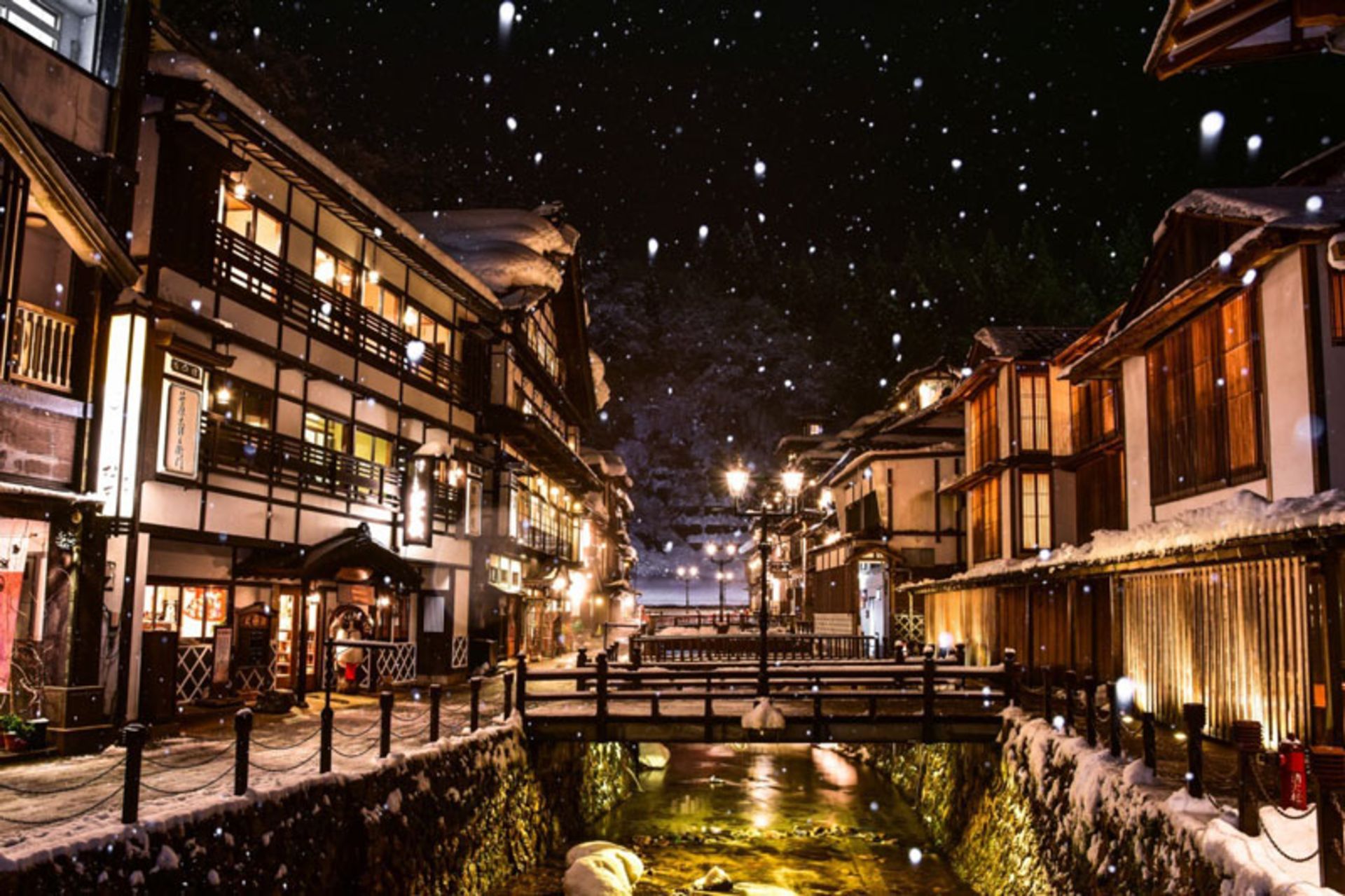 Japan's traditional snowy onsen village at night