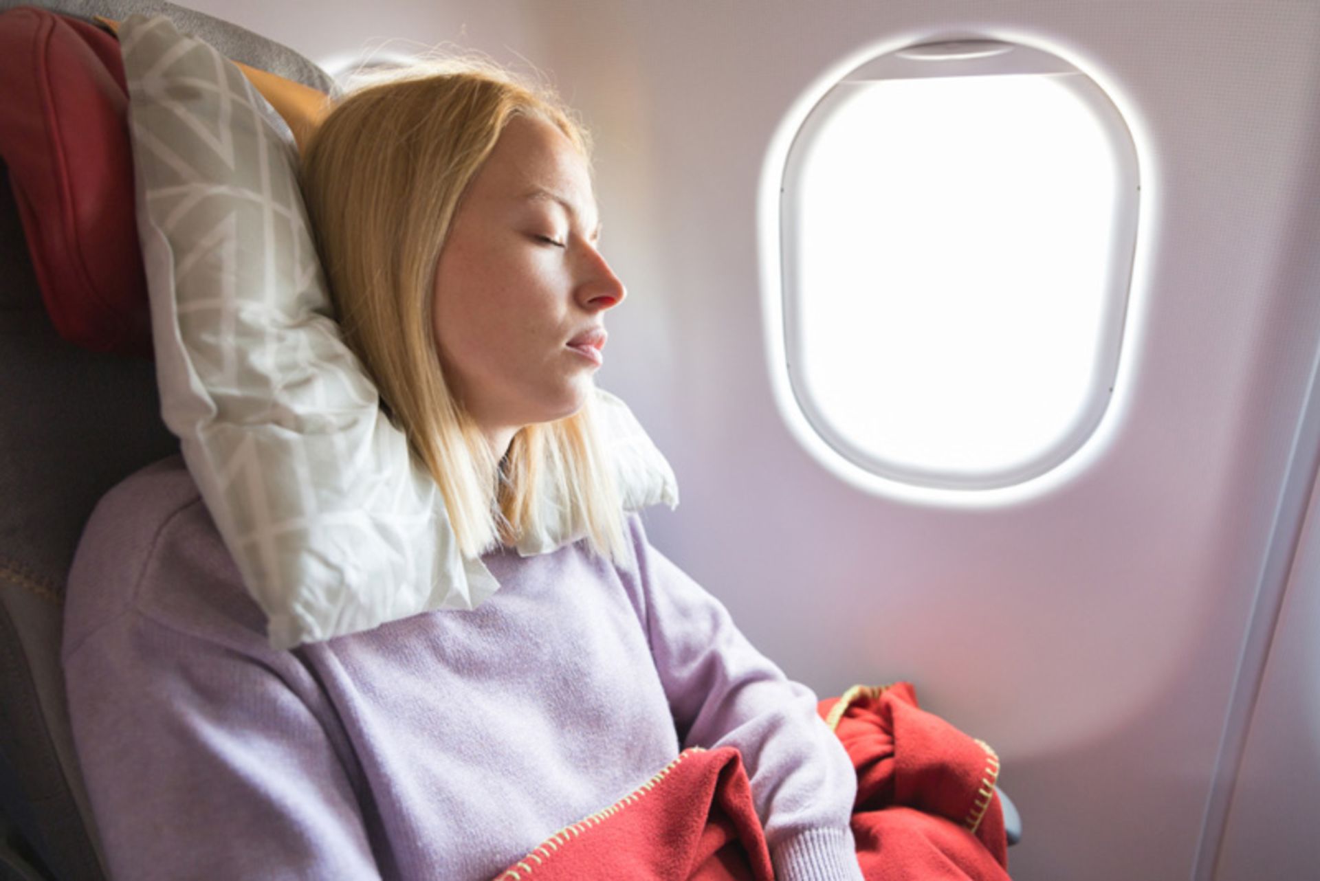 Sleeping passengers with comfort equipment on the plane