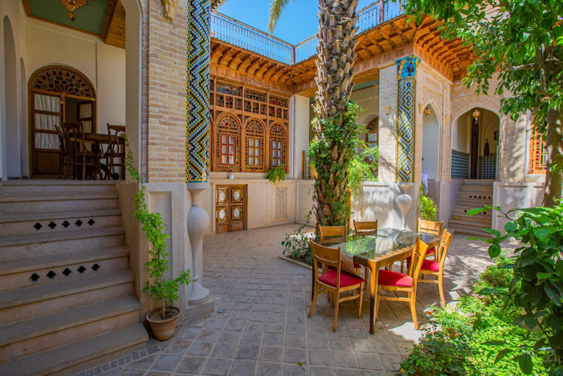 Table and chairs in the courtyard of Iranmehr Shiraz Boutique Hotel