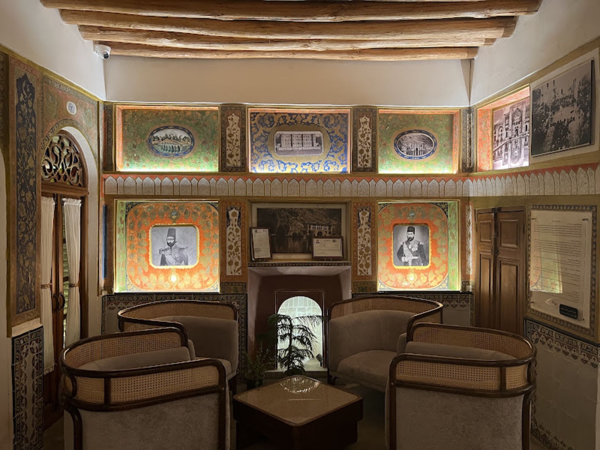 Pictures of famous personalities on the wall of boutique hotel in Sarm al-Doulah and Noushk, Kermanshah