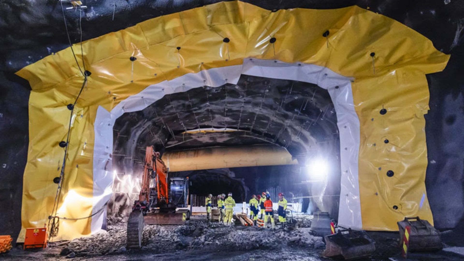 Installing yellow waterproof insulation layers in the walls of the Rogue Fast tunnel