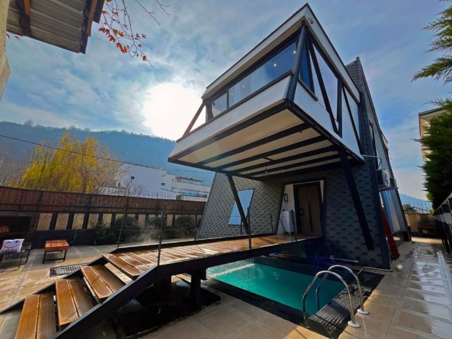 The large yard and pool of the Swiss Chalet of Chalous comfort