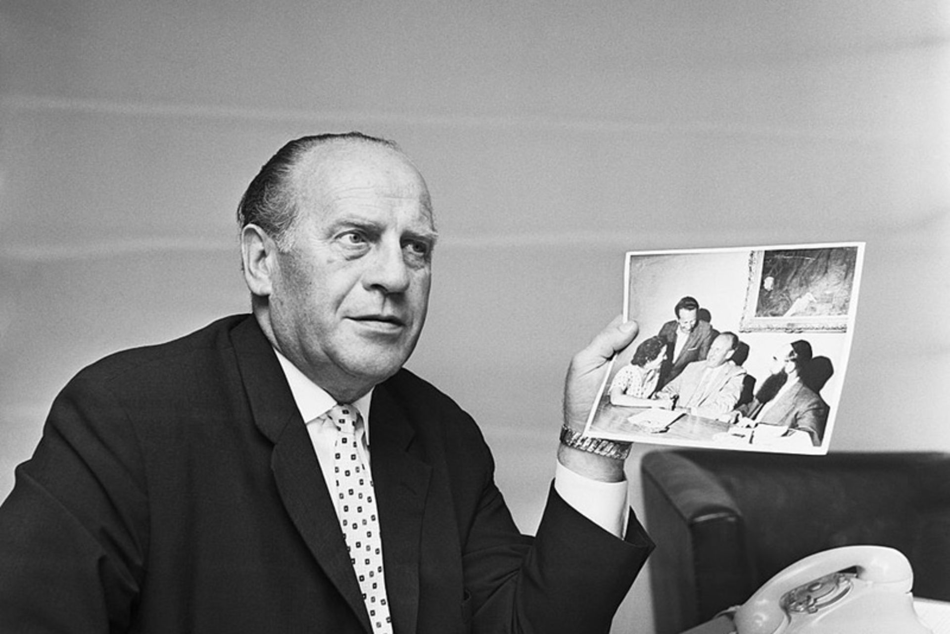 Oskar Schindler holding a picture
