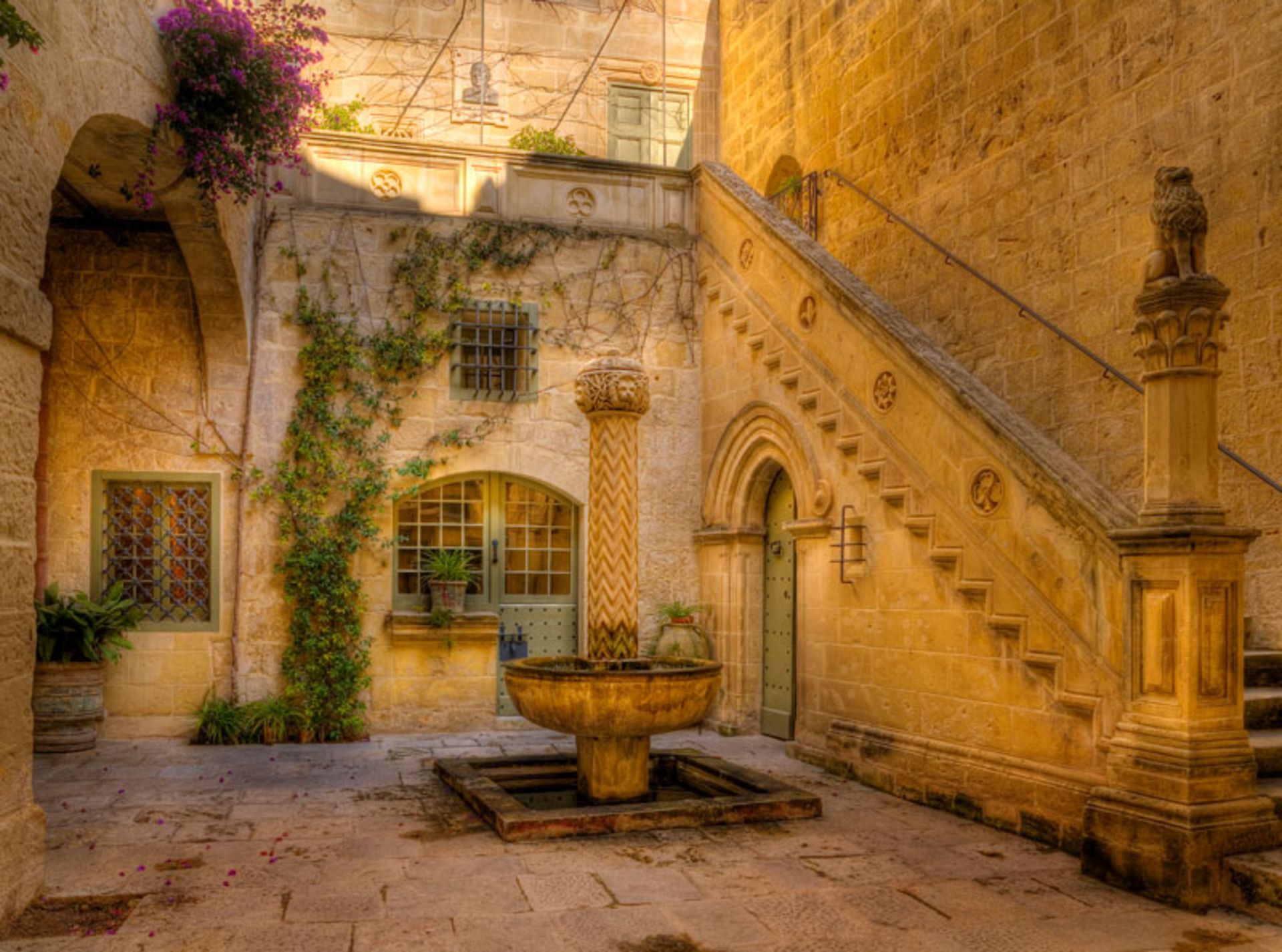 Cozy and spectacular inner courtyard of a historic stone-walled mansion in Malta