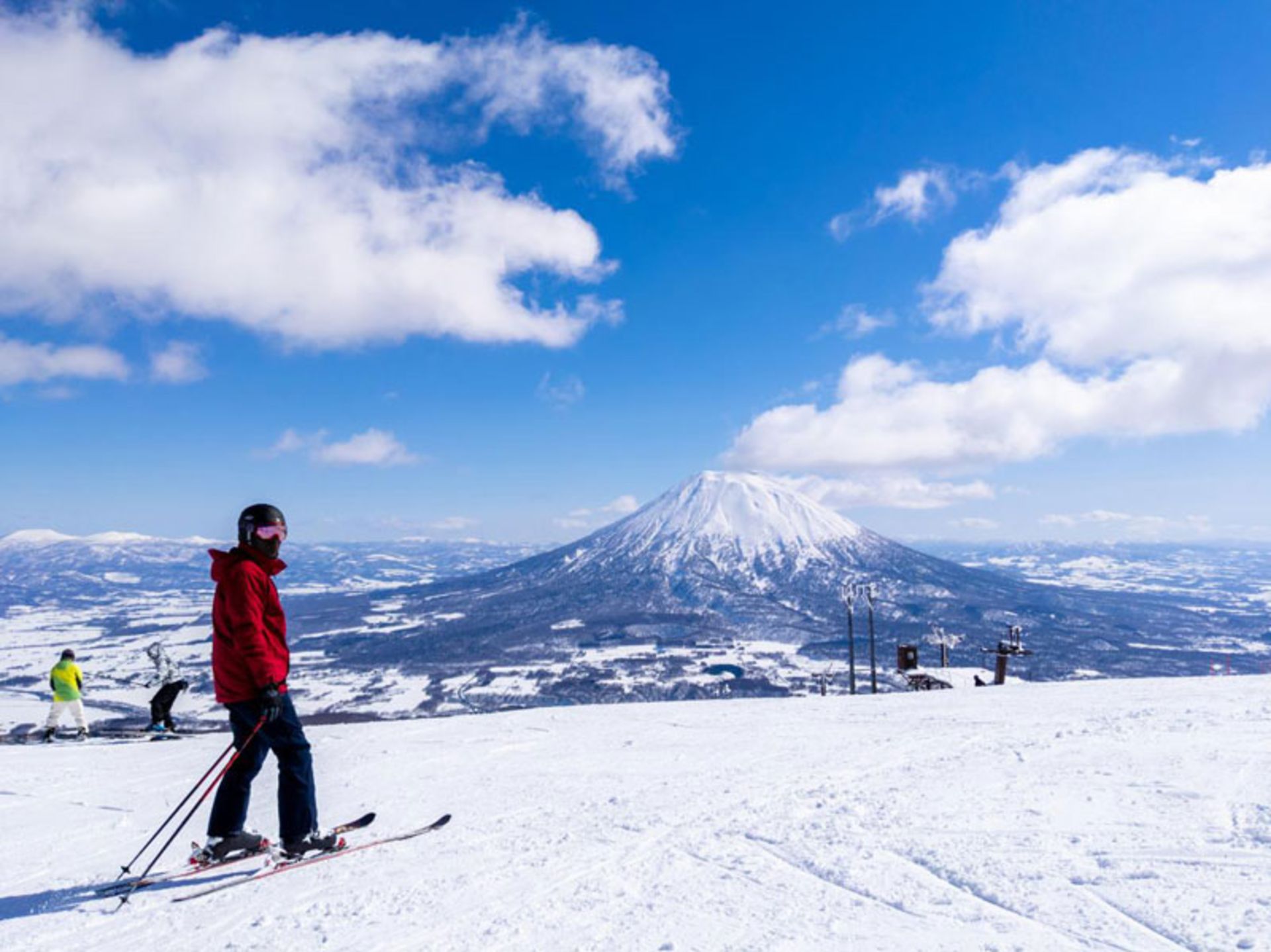 A skier watching a volcanic mountain in Hokkaido, Japan