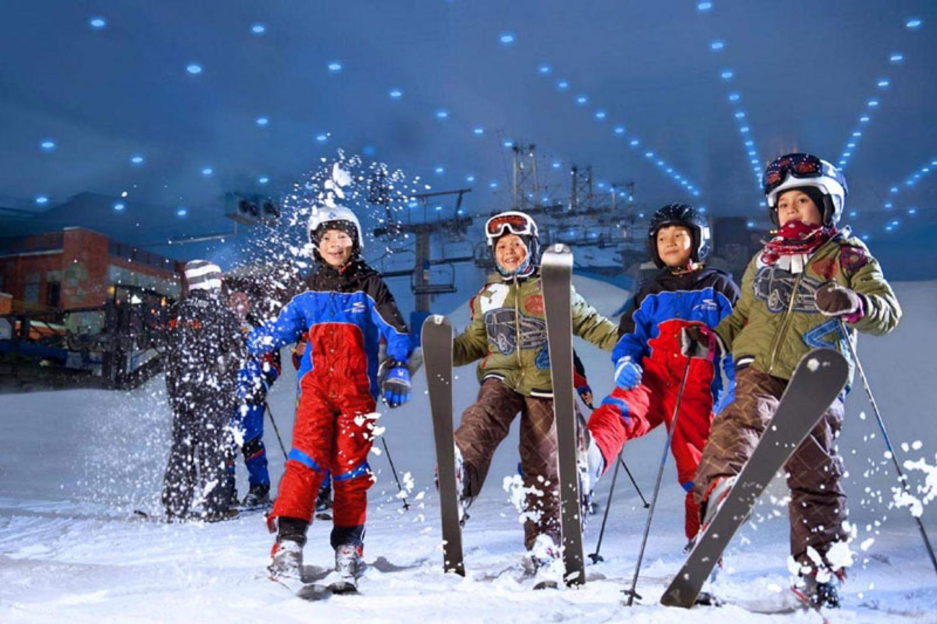 Children in full ski suits and helmets