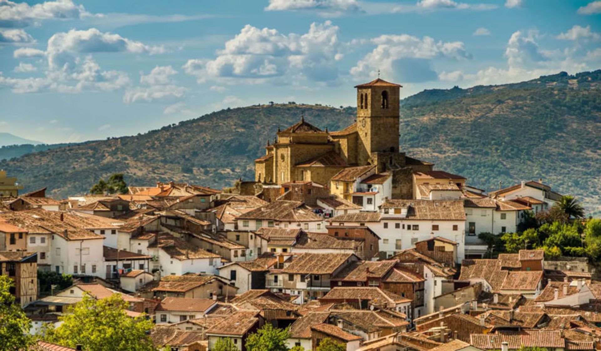 View of historic village and stone church in Extremadura region