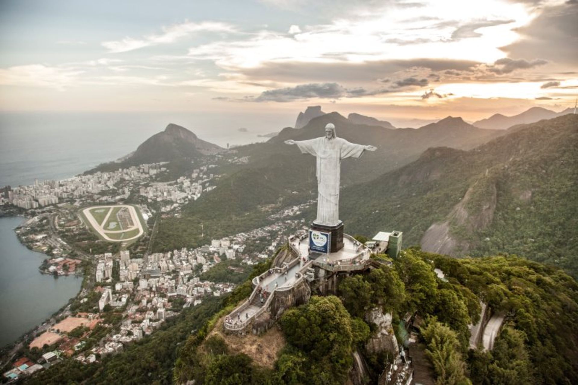 The statue of Christ the Redeemer and the nature and urban context around it in Brazil