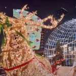 A picture of a Christmas night market with a reindeer statue in Dubai