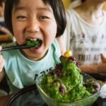 A child eating Japanese green tea flavored kakigori dessert