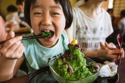 A child eating Japanese green tea flavored kakigori dessert