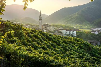 Prosecco hills with vineyards and a village in the background in Treviso