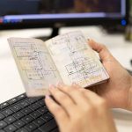 Stamped pages of a passport in a person's hand