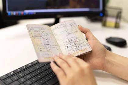 Stamped pages of a passport in a person's hand