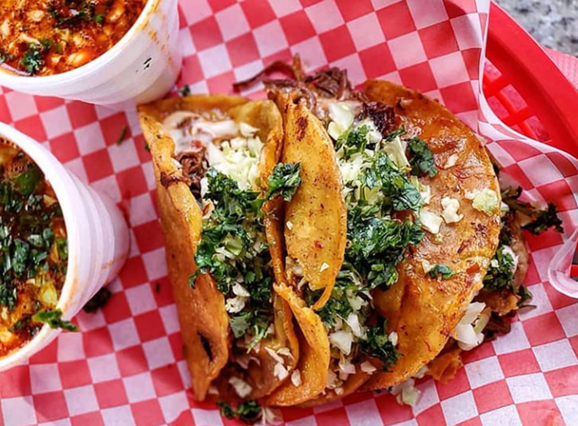 Two taco sandwiches on a square table