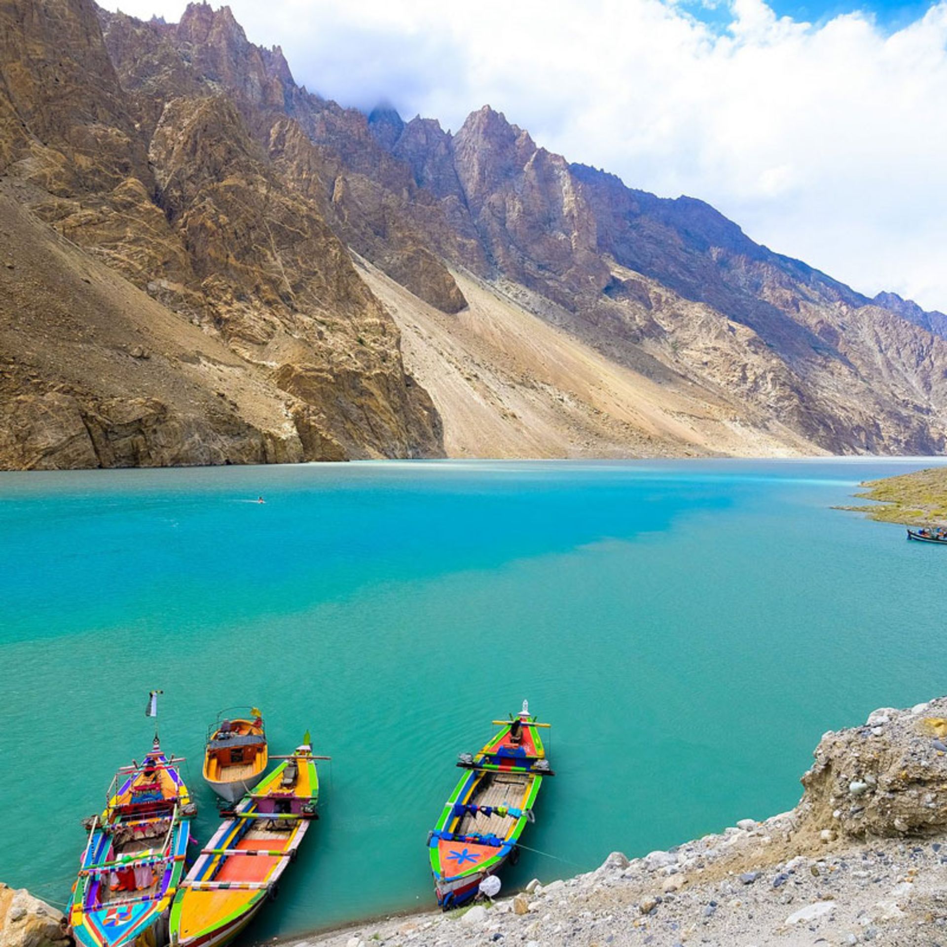 Colorful boats in the emerald waters of Attabad Lake