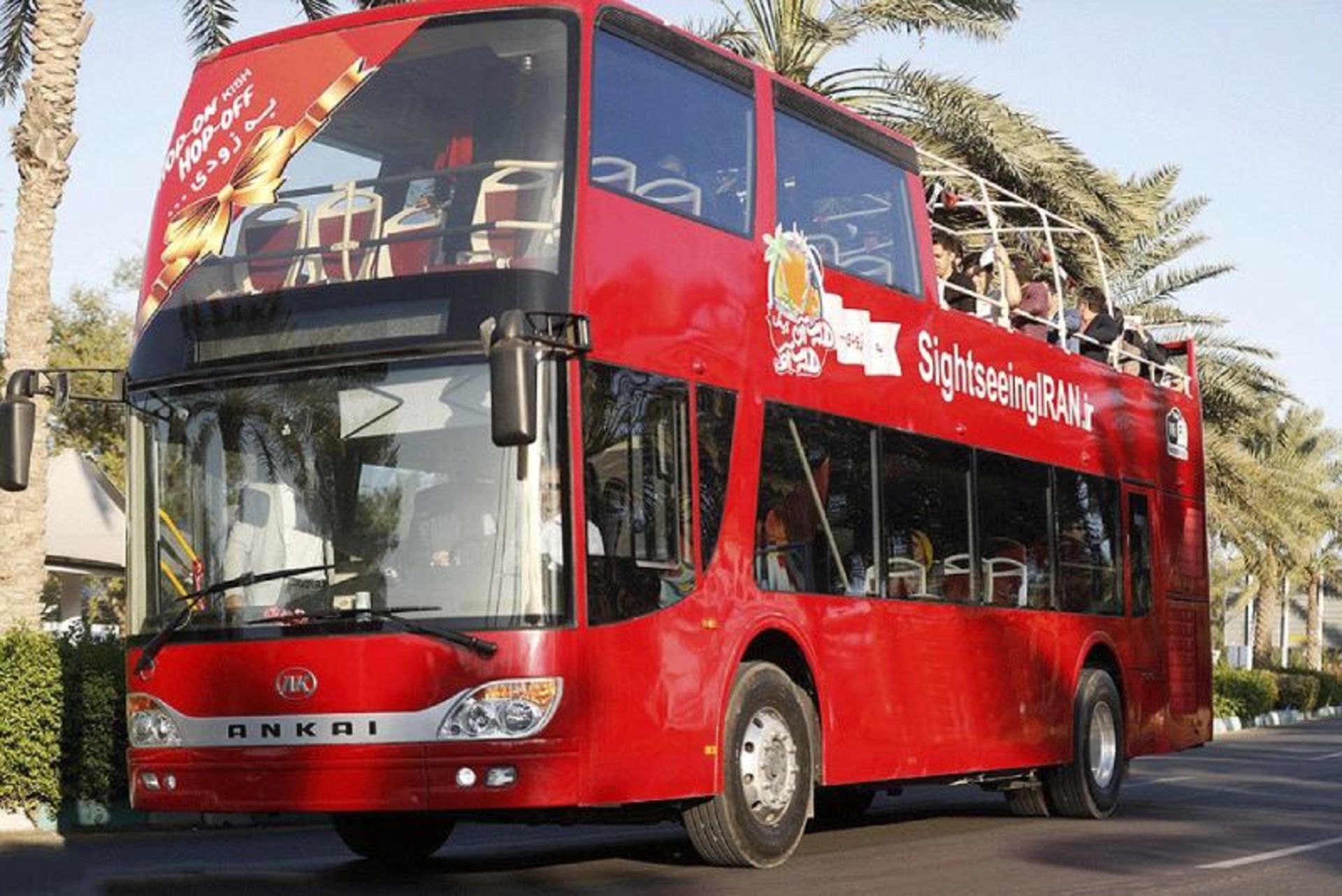 Tourists in a double-decker hop-on, hop-off bus
