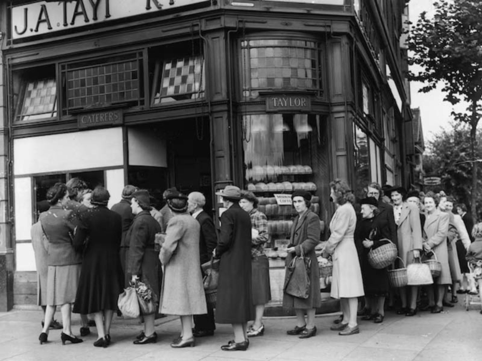 A long line of people in front of the bakery to receive bread quota