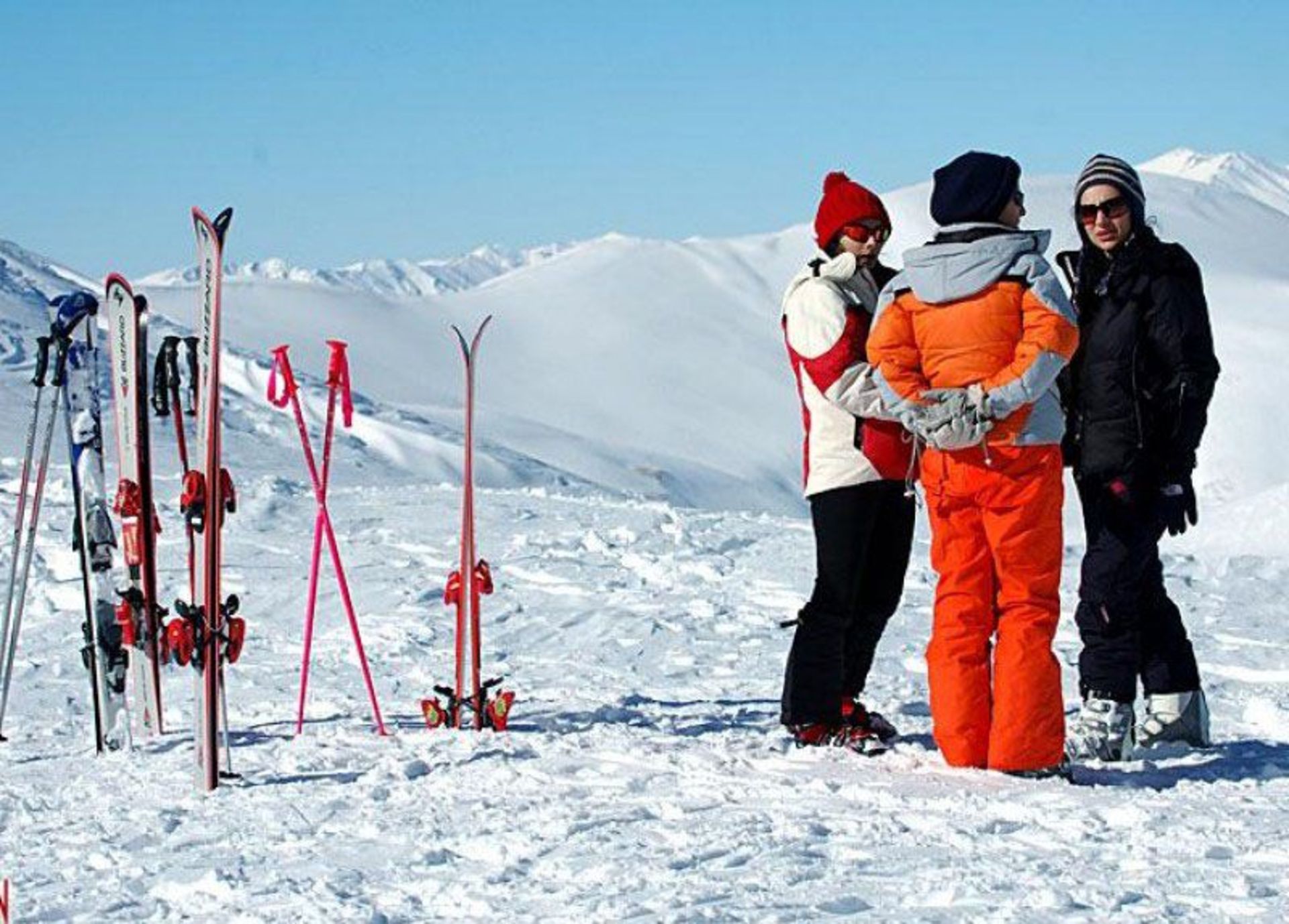 Women with ski equipment at the resort's ski station