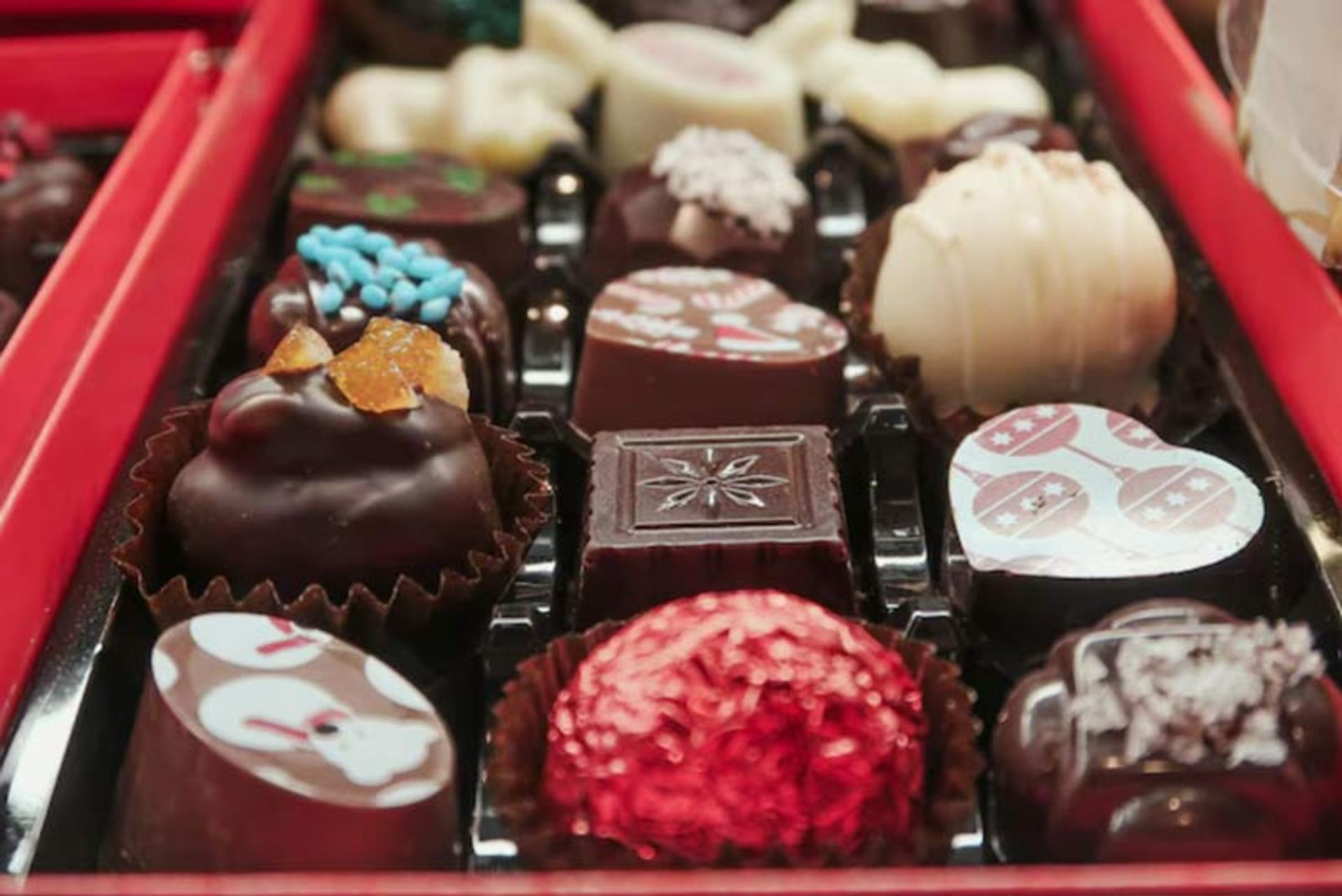 A box of handmade and decorated chocolates in different flavors