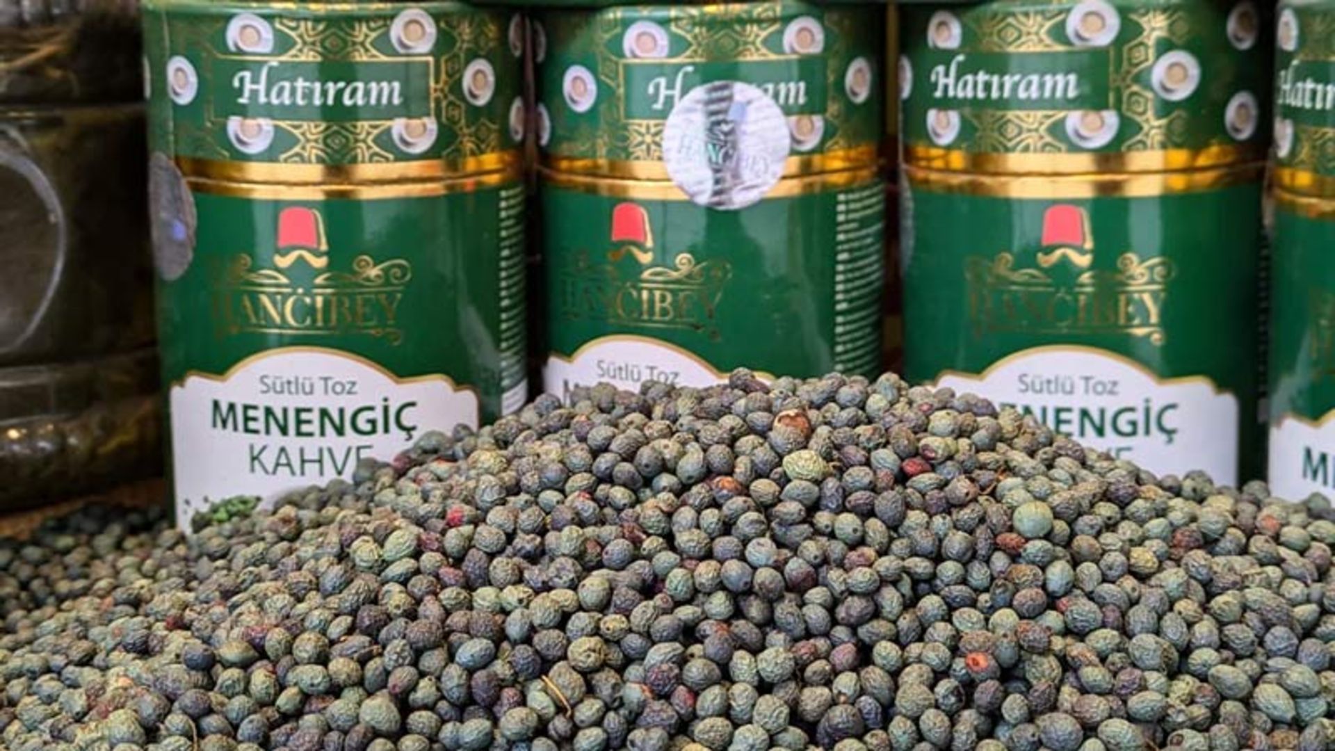 Raw, green pods on front of packaged cans