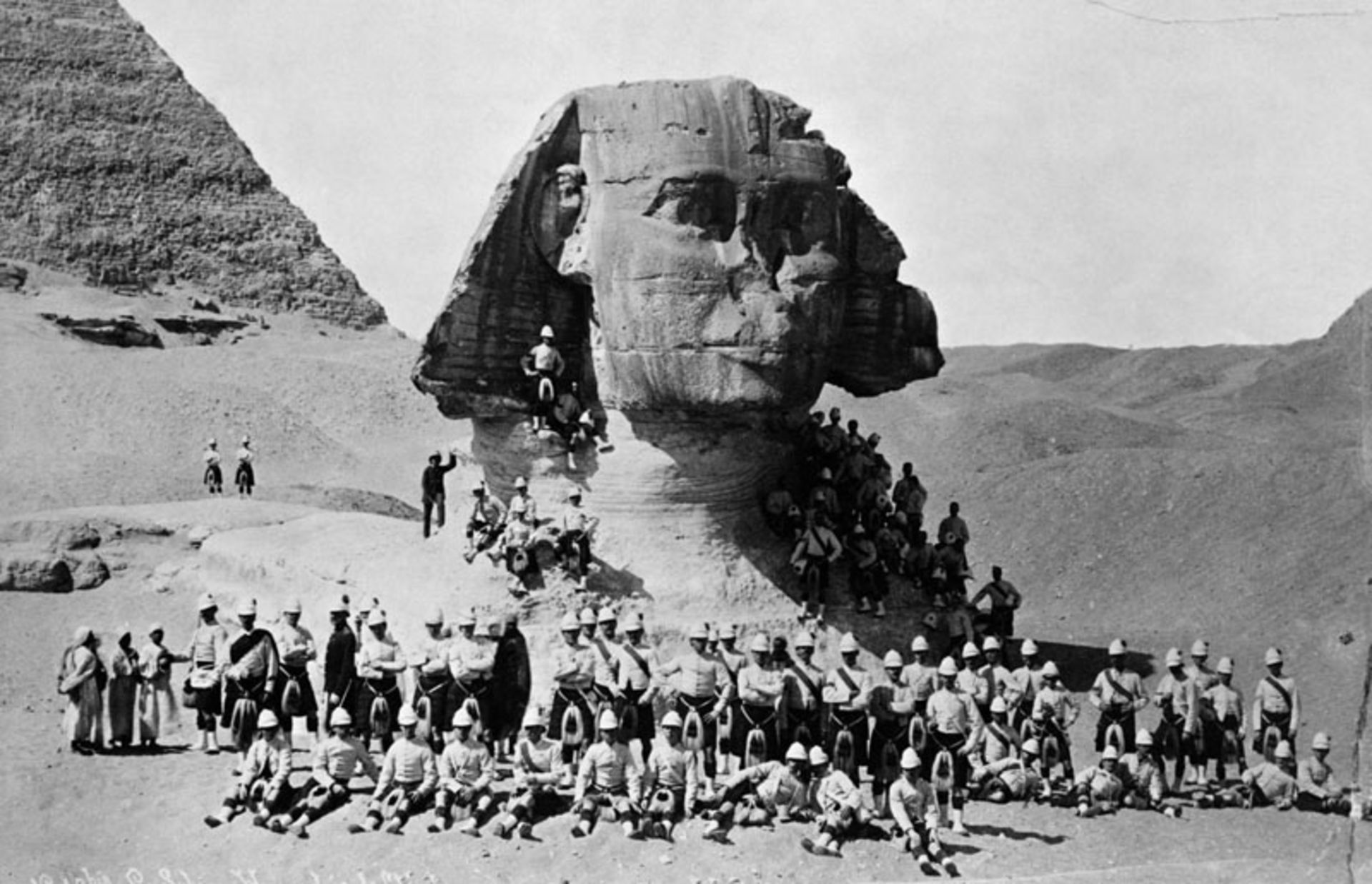 Old black and white photo of a souvenir photo with the statue of the Great Sphinx of Giza