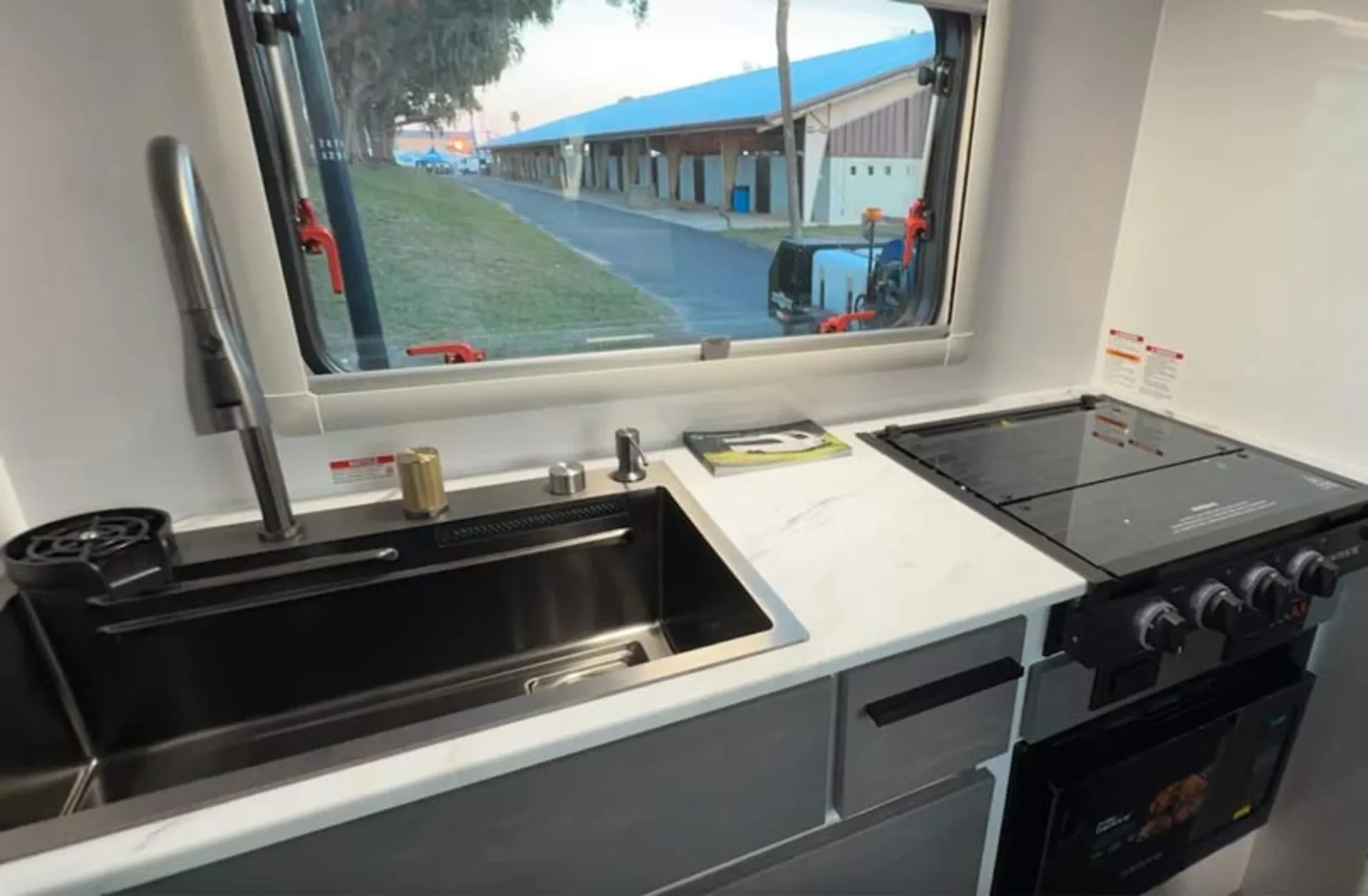 The kitchen area in a luxury caravan is equipped with a modern tabletop gas stove