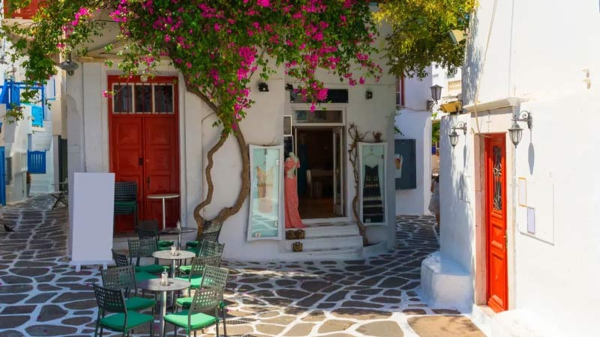 White wall and paper flowers in a stone alley