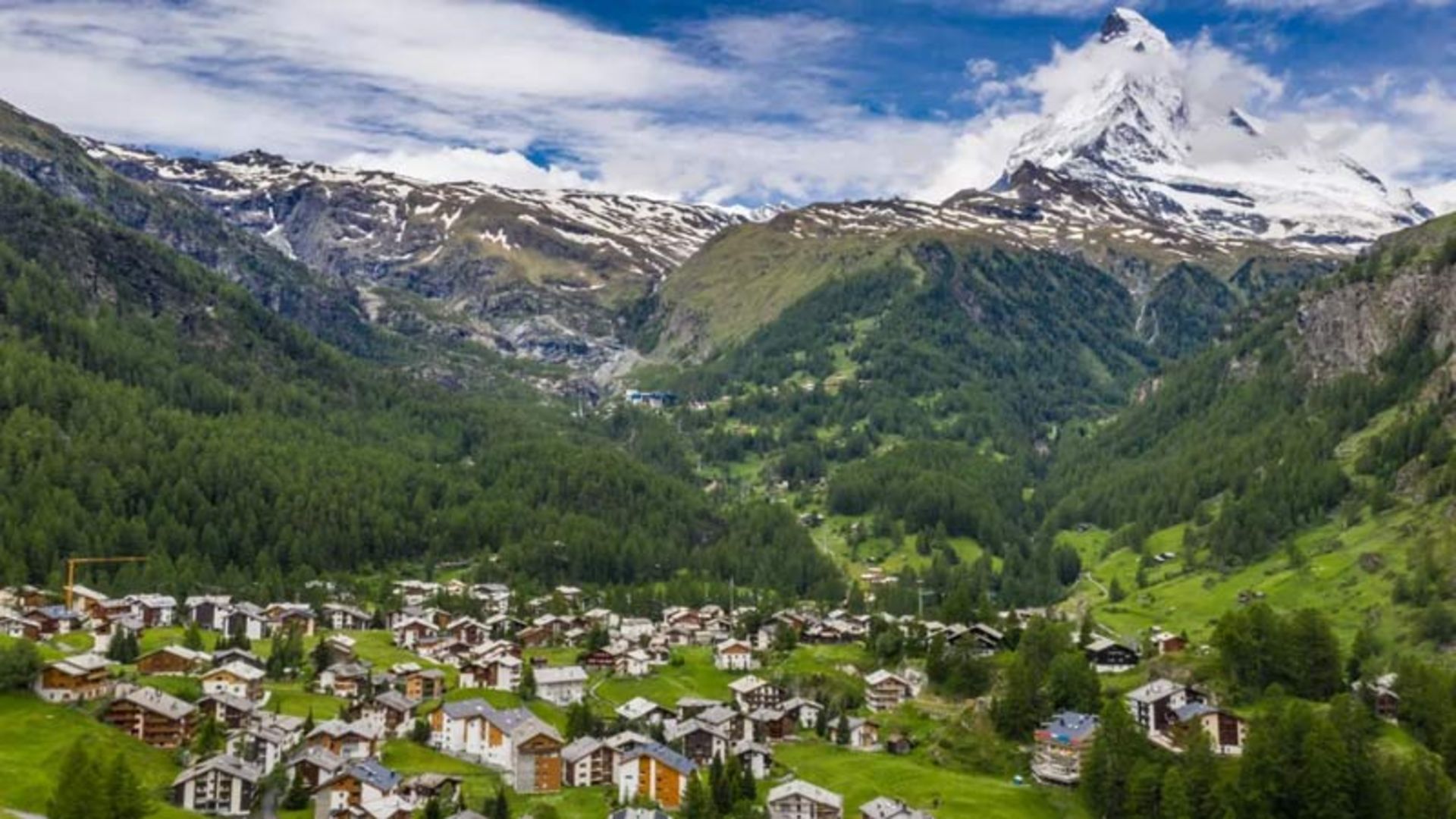 A mountain village at the foot of a snowy peak 