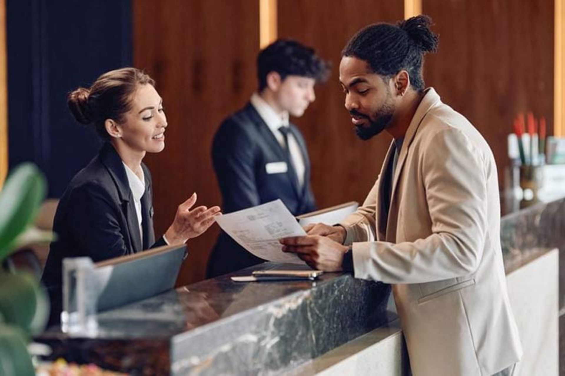 The traveler's conversation with the hotel reception staff in front of the counter