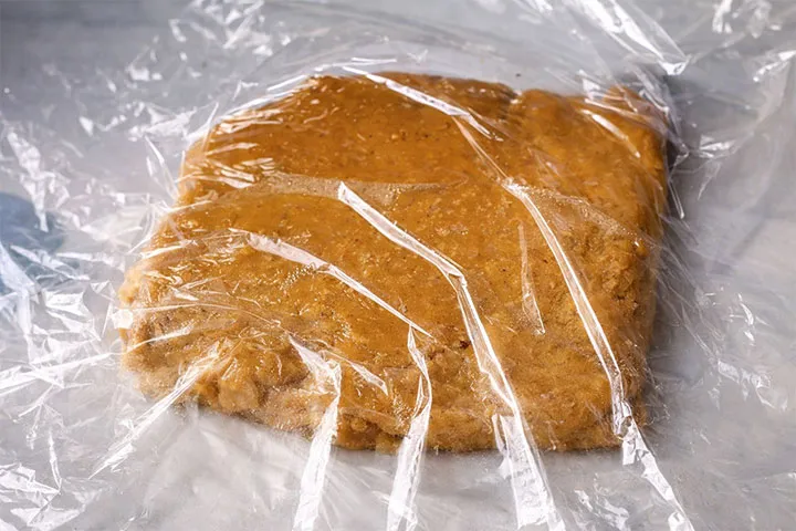 Spreading cellophane on the sweet chickpea dough