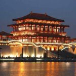 A multi-storey building with orange lighting at night