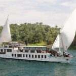 A traditional Egyptian sailboat with two large white sails