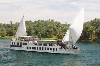 A traditional Egyptian sailboat with two large white sails